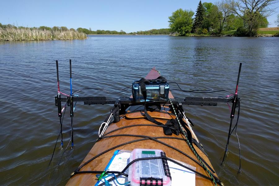 Electronic mapping equipment mounted on a kayak going down a river.